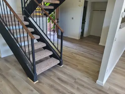 Completed flooring installation: Carpet stairs and new wood floor
