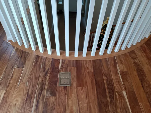 Hardwood flooring installed in a landing area by Valley Flooring