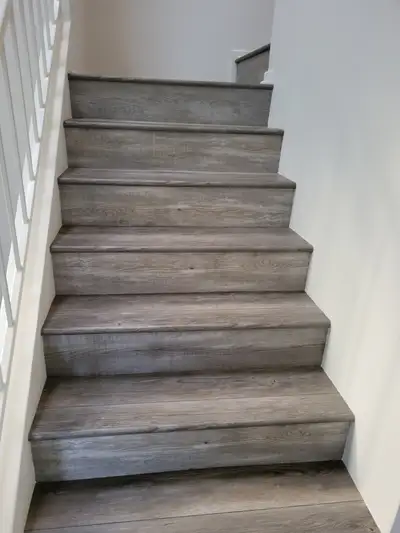 Completed flooring installation: New gray staircase