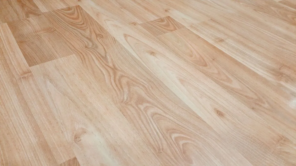 Smooth light brown luxury vinyl plank flooring with natural wood-look texture