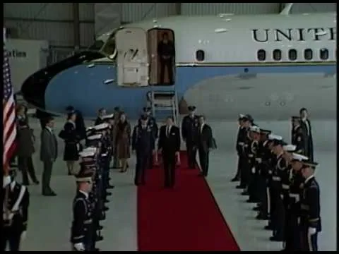 Dignitaries walking the red carpet near Air Force One during the official state arrival ceremony
